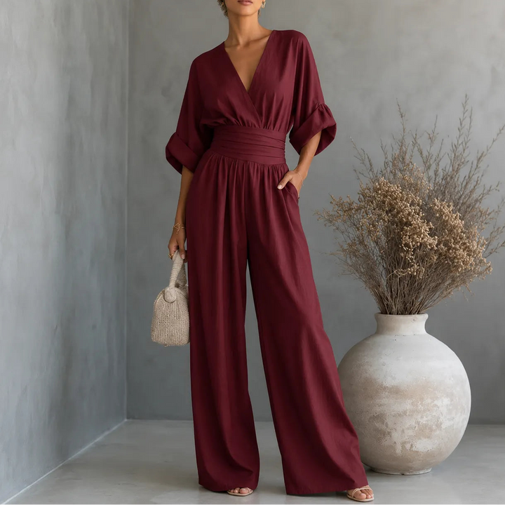 Soléra – Wide Leg V Neck Jumpsuit with Pleated Waist Sash