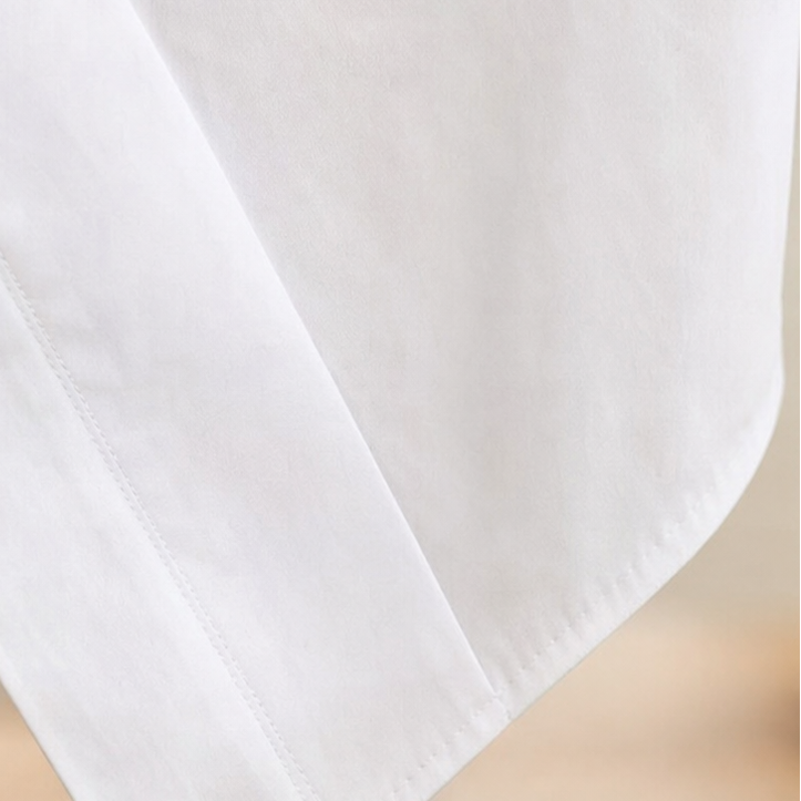 Vela Twist – Diagonal Wrap Hem Cotton Shirt